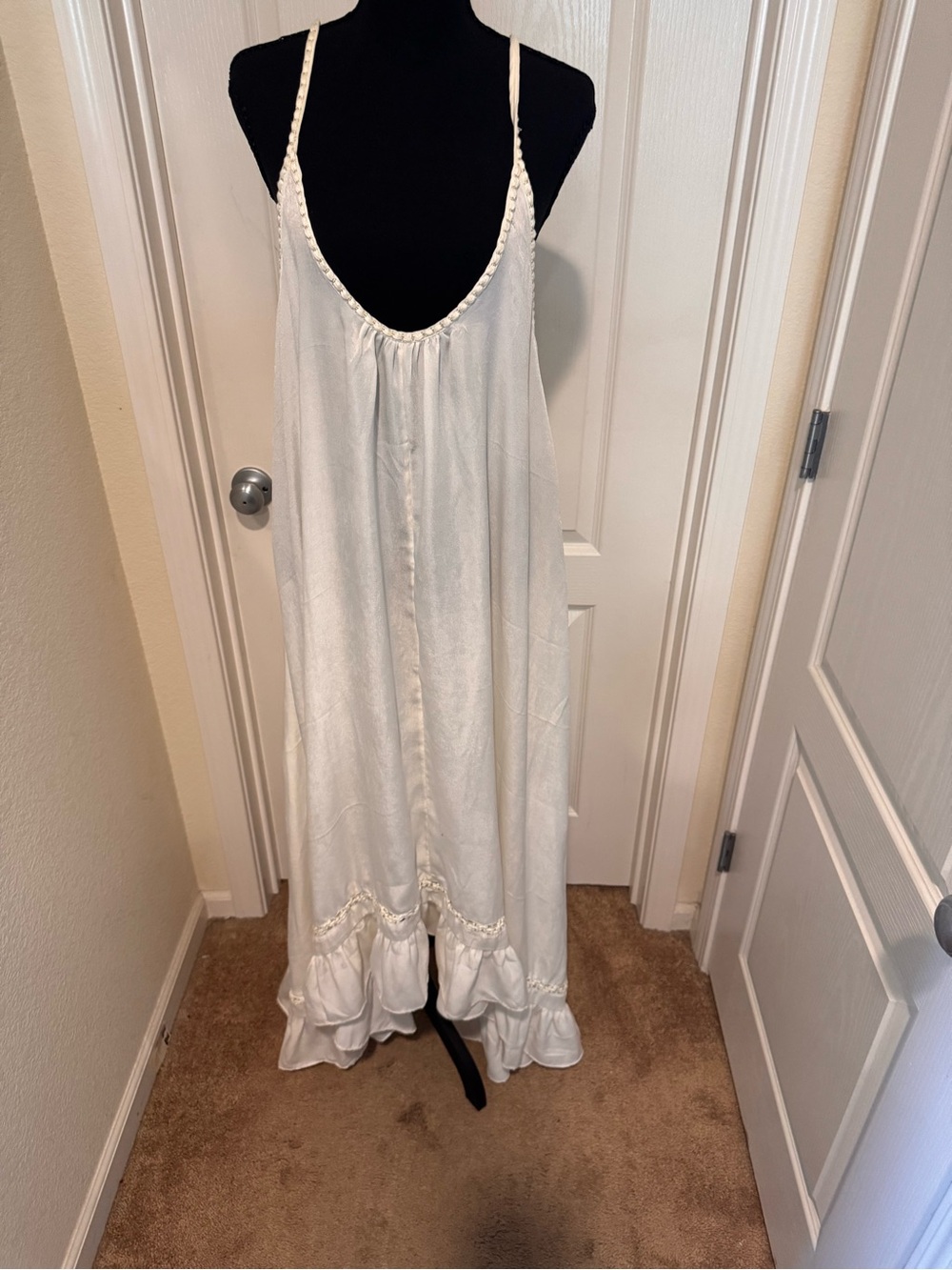 The dress in the image is the FP One Odette Ruffle Slip dress by Free People
